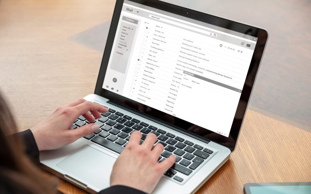 Email client list, woman hand on the computer laptop, inbox e mail message on the screen, close up