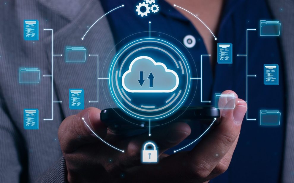 Vertical Photo of A man employs cloud-based computing on his smartphone to facilitate data transmission, storage, backup, and access